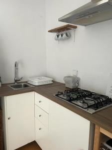 a kitchen with a stove and a sink at Paradise Villa for 6 at Odemira River&Country in Santa Clara-a-Velha