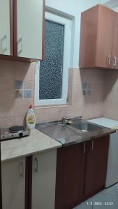 a kitchen with a sink and a window at Pejovic Guest House in Sutomore