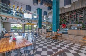 a restaurant with tables and chairs and a checkered floor at The Regency Cosy Apartment- 419 in Pretoria