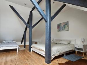 a bedroom with two beds in a attic at Le 189 : Superbe triplex centre Béthune in Béthune