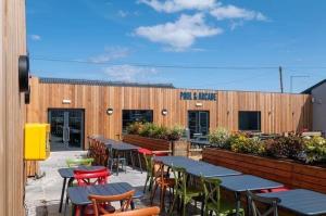 a restaurant with tables and chairs in front of a building at Highway in Lossiemouth