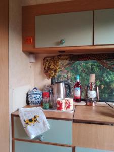 a kitchen with a counter top with a stove top oven at Retro caravan 