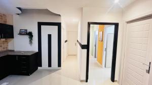 a hallway with black and white walls and doors at Beautiful Partition Room in Al barsha 1 Near Metro in Dubai