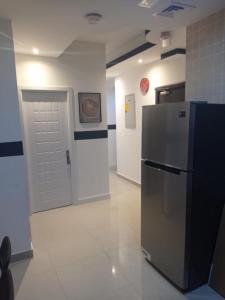 a room with a refrigerator and a white door at Beautiful Partition Room in Al barsha 1 Near Metro in Dubai
