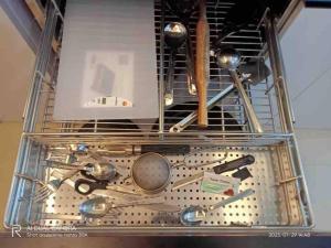 a metal rack with utensils in a dishwasher at Boho Studio in Pune