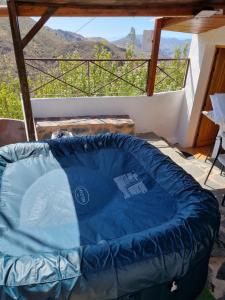 a large blue inflatable bed on a balcony with a view at Casa Los Manantiales in Tejeda