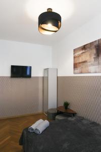 a room with a bed and a lamp and a table at ClickTheFlat Three Crosses Square Apart Rooms in Warsaw