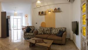 a living room with a couch and a table at Tranquilo Boutique Hostel - Dahab in Dahab