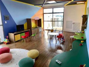 a room with a room with tables and chairs at AP1422 ar condicionado piscina academia coworking etc in Juiz de Fora