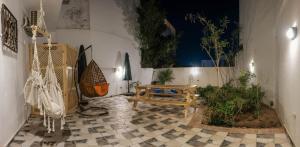a room with a bench and some plants at Tranquilo Boutique Hostel - Dahab in Dahab