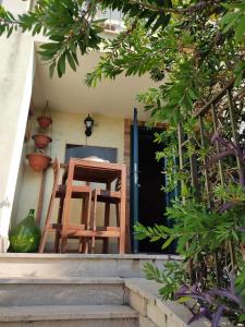 a wooden chair sitting on the front porch of a house at Le Stelle Antiche - Giubileo 2025, concorsi aeronautica, Ryder Cup, Guidonia Montecelio, Roma, Tivoli in Marco Simone