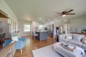a living room with a couch and a kitchen at Stylish Tulsa Home with Modern Updates! in Tulsa