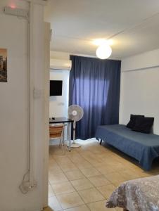 a bedroom with a bed and a desk in a room at Jason Apartment in Kato Lakatamia