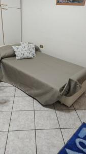 a large bed sitting on top of a tiled floor at La Libellula in Ortona