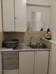 a kitchen with a sink and a bowl on the counter at Jason Apartment in Kato Lakatamia