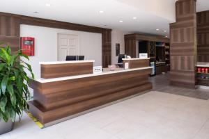 a lobby of a salon with a reception counter at Hilton Garden Inn Baton Rouge Airport in Baton Rouge