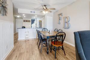 a dining room and kitchen with a table and chairs at The Southern Harmony in Folly Beach