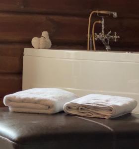 two towels sitting on a table next to a sink at "SoFly Lodge", Charm and Elegance in Noresund