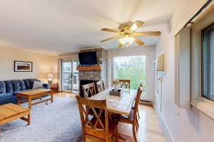 a living room with a table and a ceiling fan at Mountainside Resort B202 in Stowe