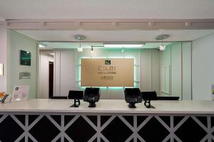 a room with a counter with chairs and a screen at Quality Inn & Suites Irving DFW Airport South in Irving