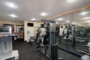 a gym with several tread machines and a mirror at Quality Inn & Suites Irving DFW Airport South in Irving