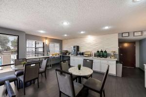 cocina con mesa, sillas y barra en Quality Inn & Suites DFW Airport South en Irving