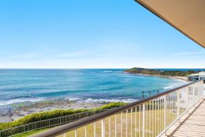 a balcony with a view of the ocean at Craigmore Penthouse in Yamba