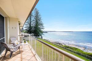 a balcony with chairs and a view of the ocean at Craigmore Penthouse in Yamba