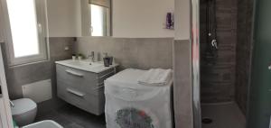 a bathroom with a toilet and a sink and a shower at La casa di Lalla in Cefalù +6 photos