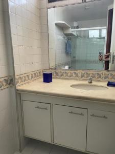 a bathroom with a sink and a mirror at Flat no Pituba Sol 302 E 311 in Salvador