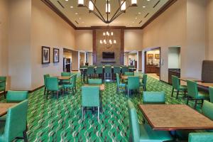 a restaurant with tables and chairs in a room at Homewood Suites Odessa in Odessa