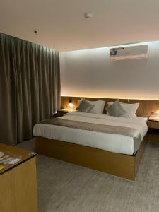 a bedroom with a large bed in a room at Yaz Hotel in Taif +42 photos