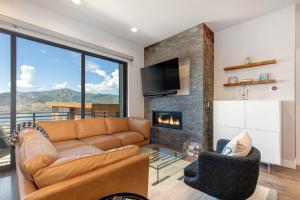 a living room with a couch and a fireplace at On Top of the Mountains - Unit B in Keetley
