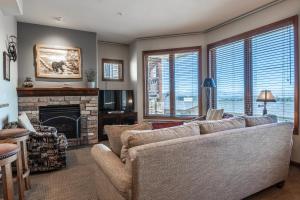 a living room with a couch and a fireplace at Eagle Run # 204 in Mammoth Lakes