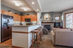 a kitchen with a bar and a living room at Eagle Run # 204 in Mammoth Lakes