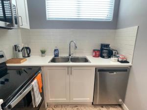 a kitchen with a sink and a counter top at Cozy basement suite in Calgary