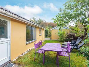 a purple table and chairs in a yard at 4 person holiday home in Hurup Thy-By Traum in Sønder Ydby
