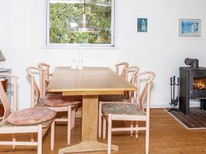 a dining room with a wooden table and chairs at 4 person holiday home in Hurup Thy-By Traum in Sønder Ydby +20 photos