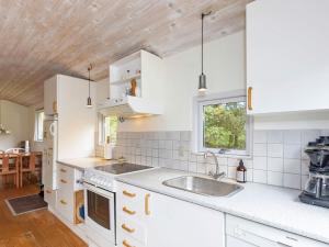 a kitchen with white cabinets and a sink at 4 person holiday home in Hurup Thy-By Traum in Sønder Ydby