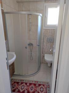 a bathroom with a shower and a toilet and a sink at Elif home in Kas