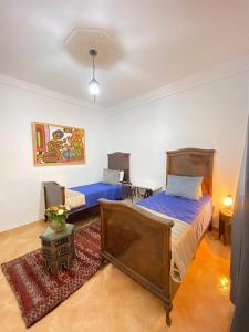 - une chambre avec 2 lits et un tapis dans l'établissement Dar Baddi, à Marrakech