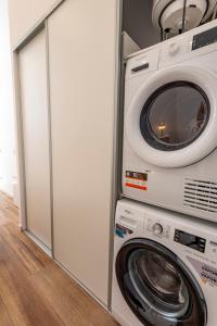 a washing machine and a washer and dryer in a room at 1 min Metro a pie, 4km de Sol, Centro de Madrid C in Madrid