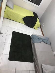een slaapkamer met een bed met een gele en zwarte deken bij casa palhoça in Palhoça