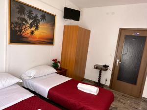 a hotel room with two beds and a television at Venice Star House in Marghera