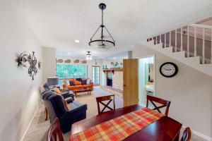 a living room with a table and a dining room at Camp Warnecke Estates Unit C204 in New Braunfels