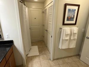 a bathroom with white towels and a sink at Cozy 1BR Apartment In Downtown Silver Spring MD in Silver Spring