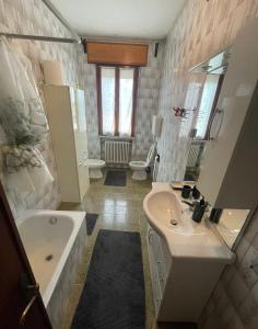 uma casa de banho com um lavatório, uma banheira e um WC. em Le ballerine em Crocetta