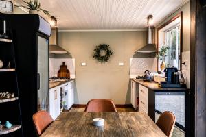 a kitchen with a wooden table and chairs at Gleneagle Tasmania in Riana