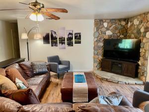 sala de estar con sofás y TV de pantalla plana. en Bigfoot Suite Hot Tub Sleeps up to 4, en North Fork