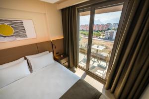 Postel nebo postele na pokoji v ubytování Casamax Suites